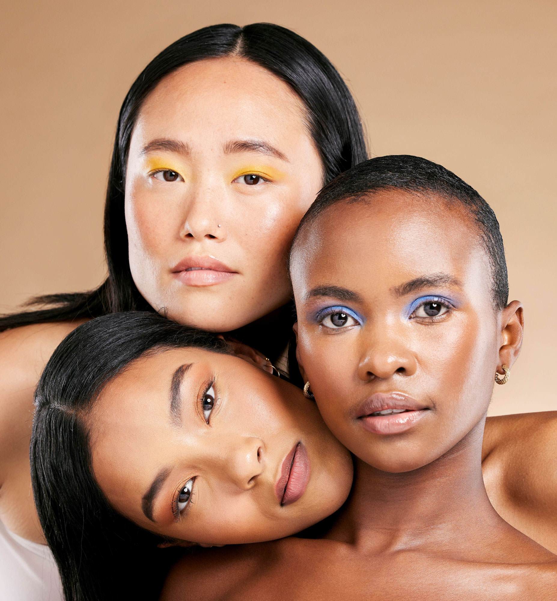 three women with colourful makeup