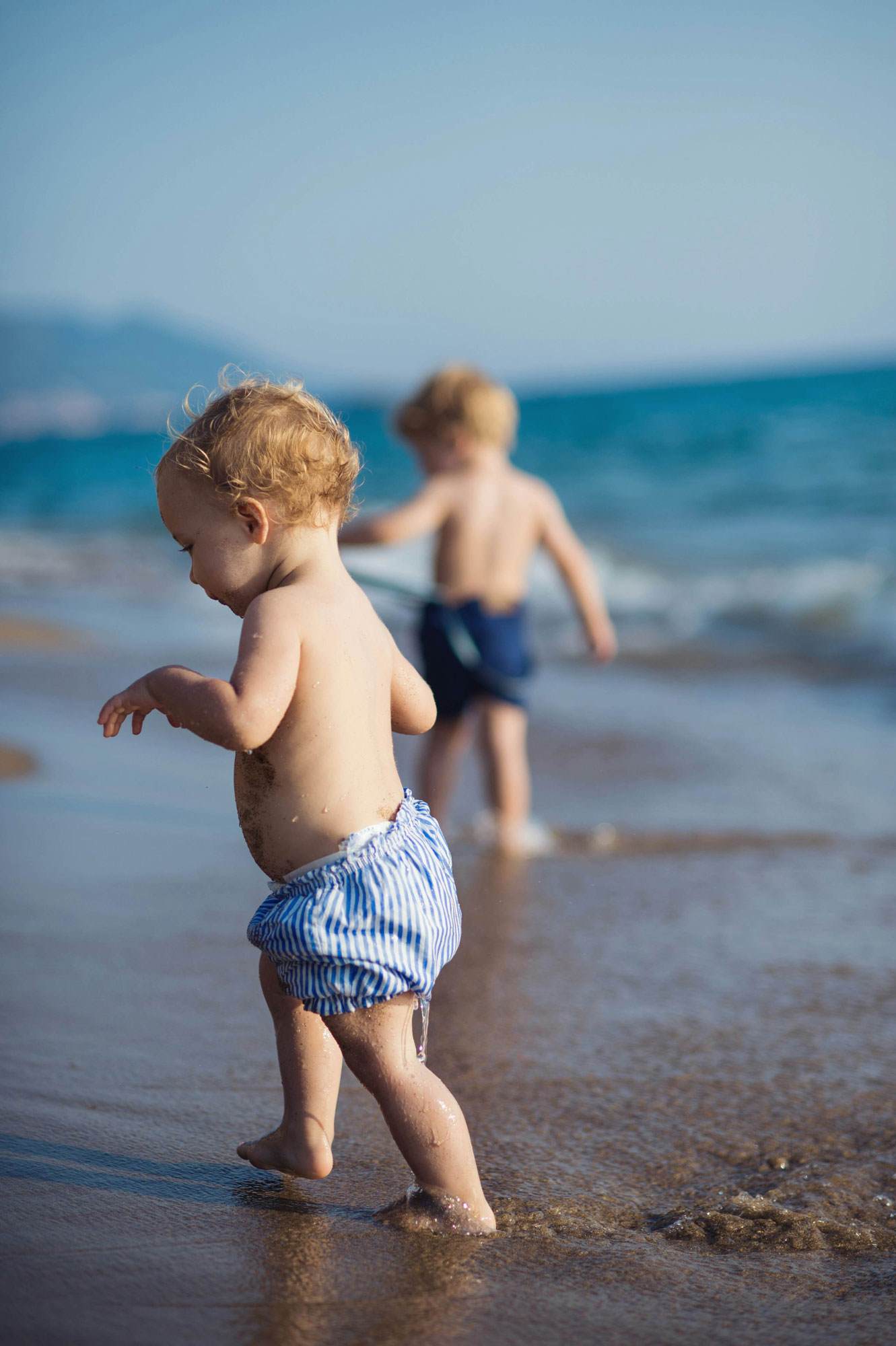 baby playing on beach