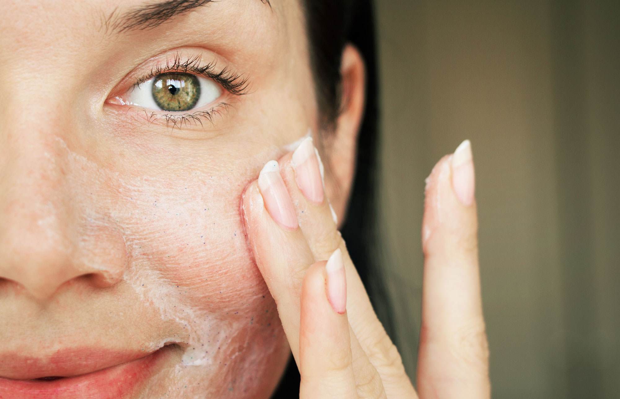 net zero powering beauty brands woman applying scrub to face female white black hair