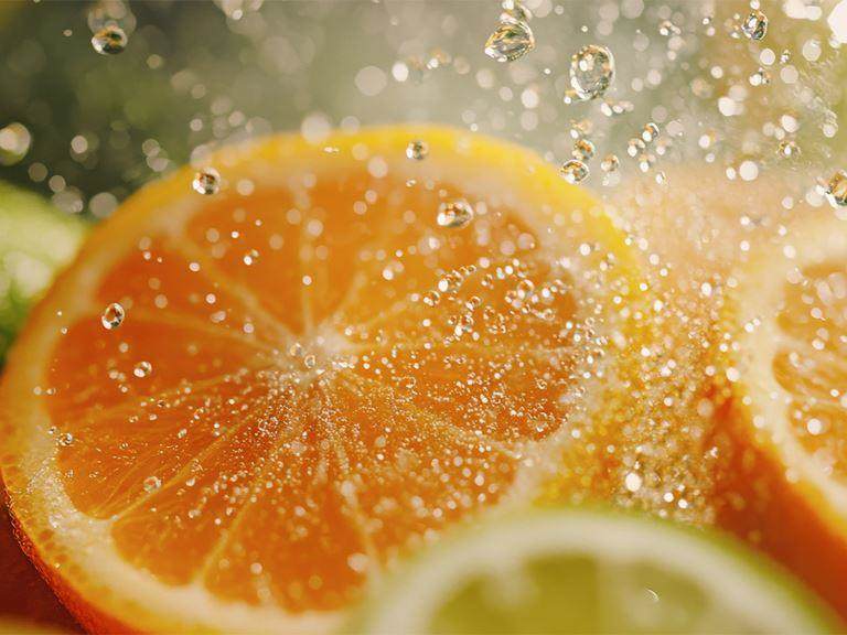 Zero Waste Sliced citrus fruit with droplets of water splashing on the slices