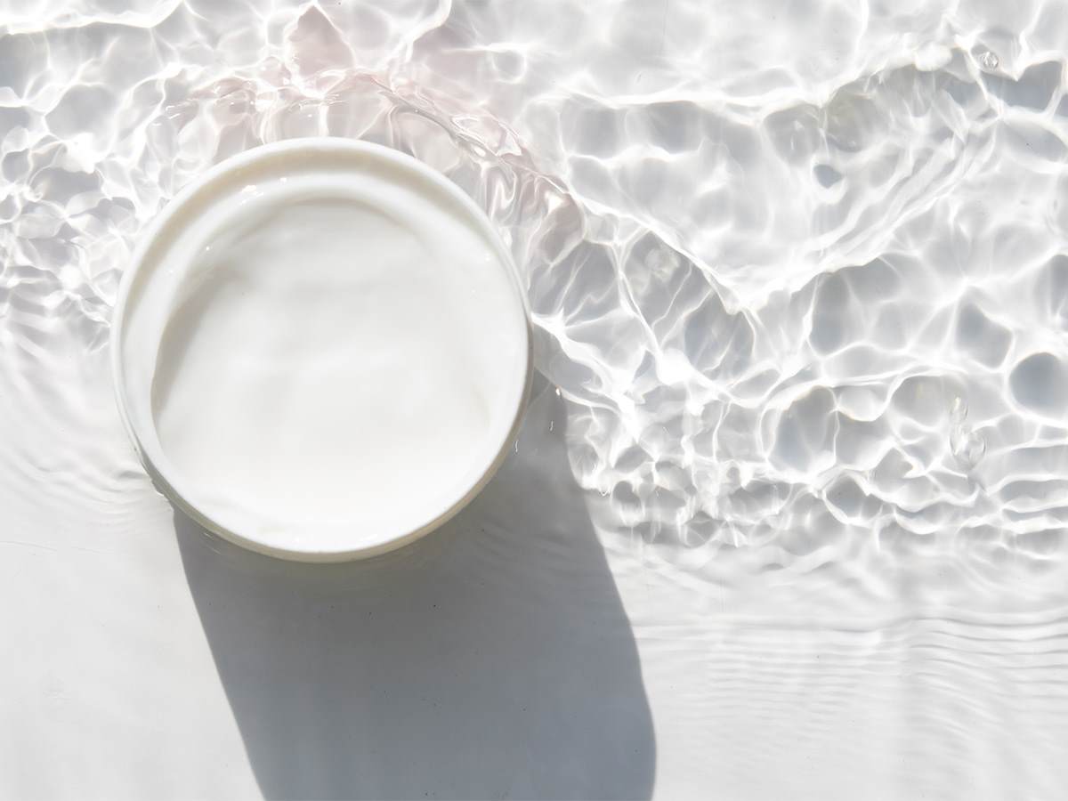 Zero water cream in round container in clear rippling water