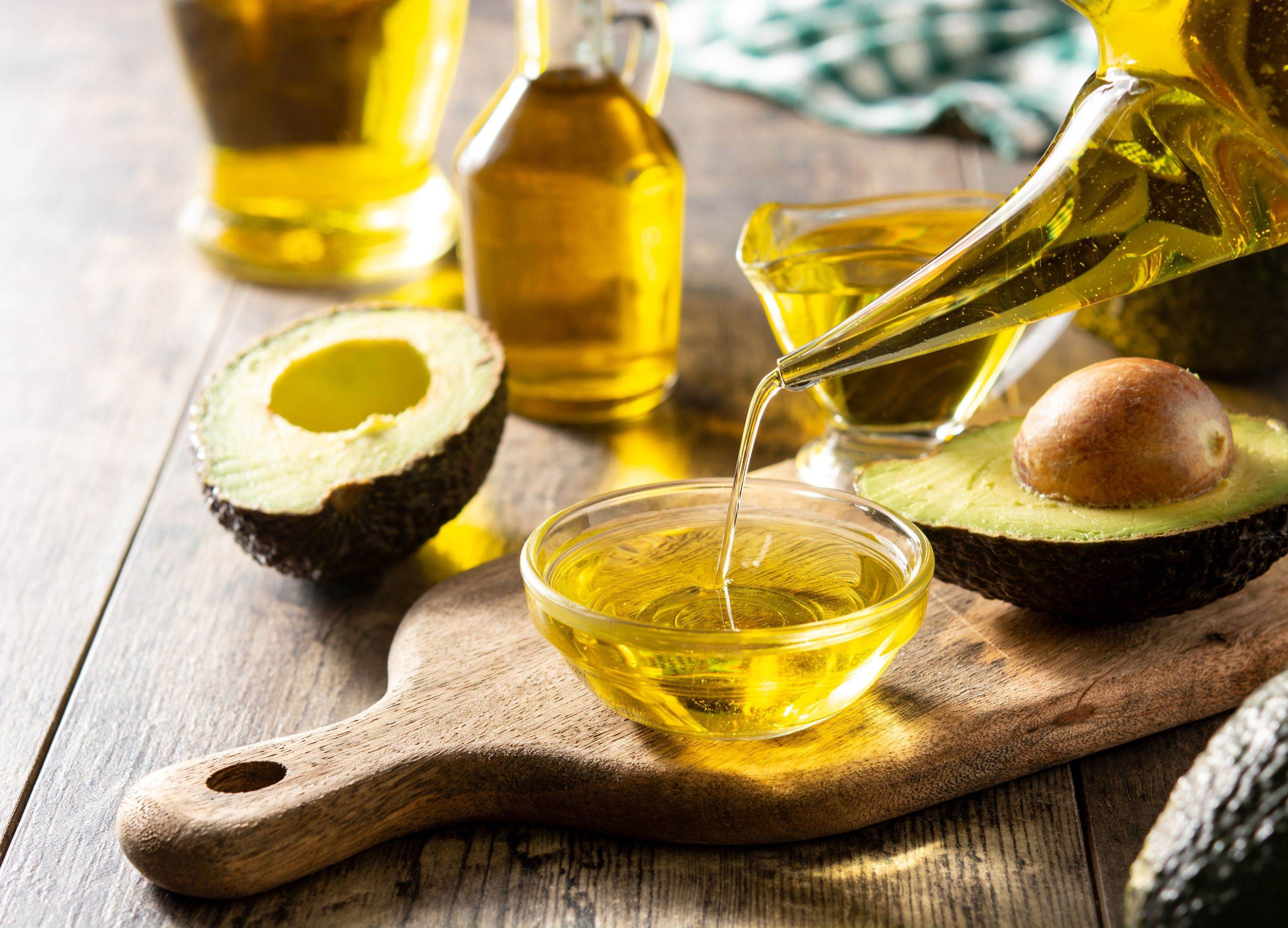 Olive oil for hair care Avocado and olive oil on wooden board landscape hair care