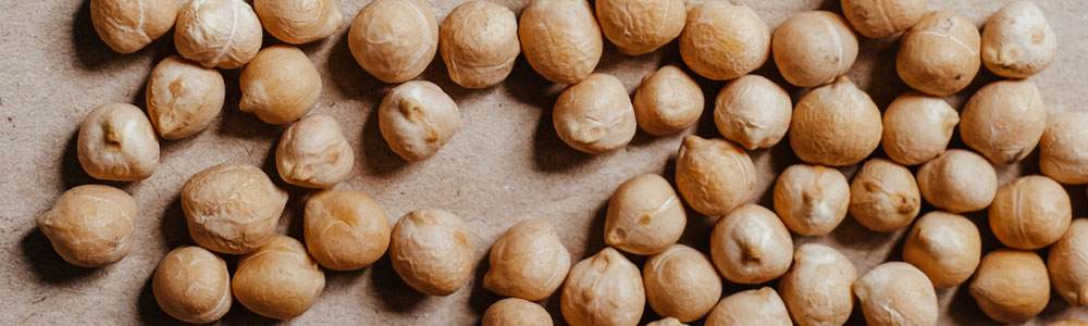Dried chickpeas on a beige linen background.