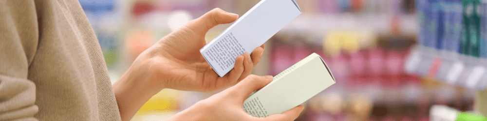 Performance driven cleansing - Customer Reading the Ingredient Labels Compares Two Skincare Products in Beauty Store. Close-up of a Female Hands, Woman Choosing Cosmetic Product