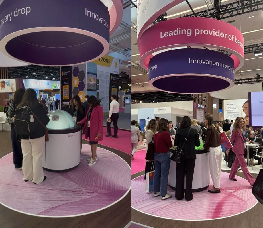 Attendees at In-Cosmetics Global 2026 looking at a hemispherical screen showing a presentation of our new ingredients.