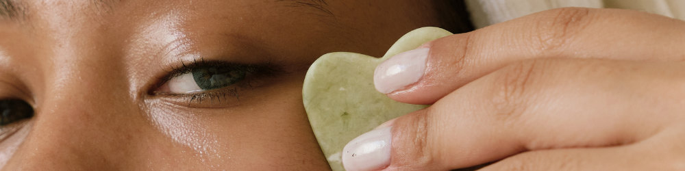 woman doing facial massage with jade stone