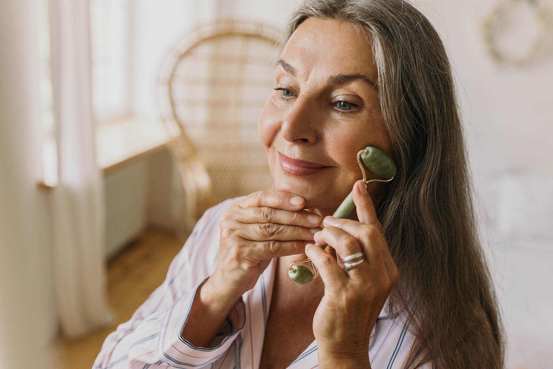 woman using facial roller