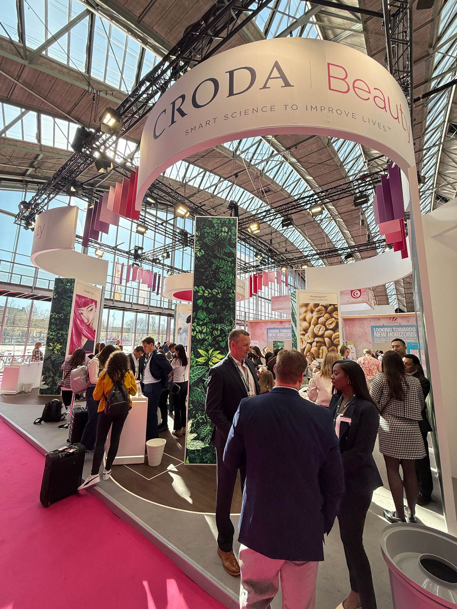 Various people standing at the Croda Beuaty stand at in-cosmetics Global 2025