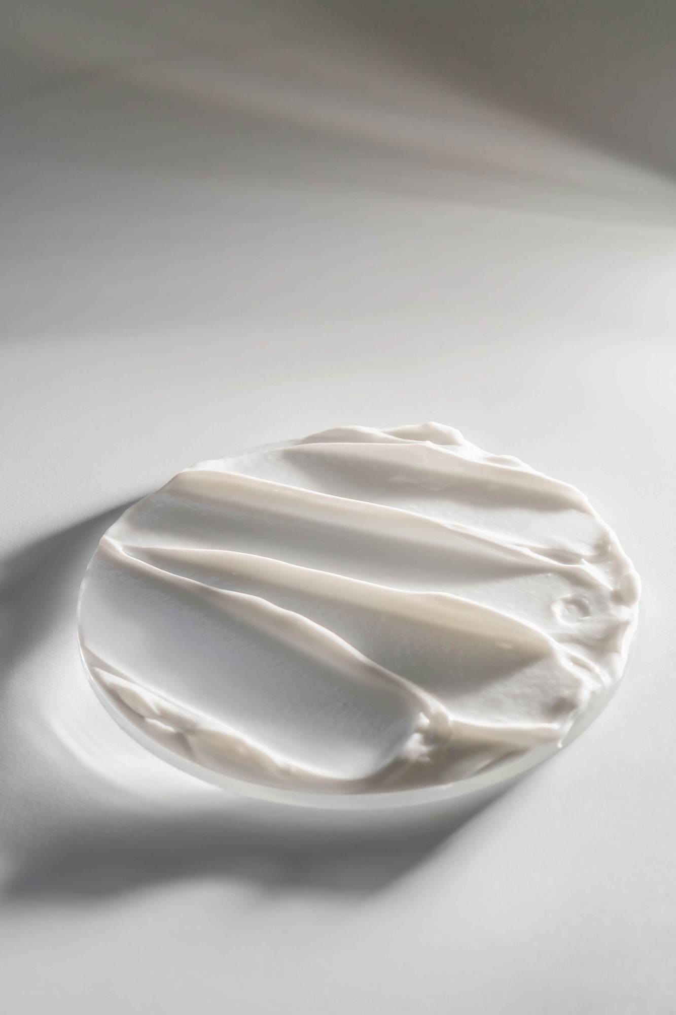 Cream swiped on plate with sun rays shining on 