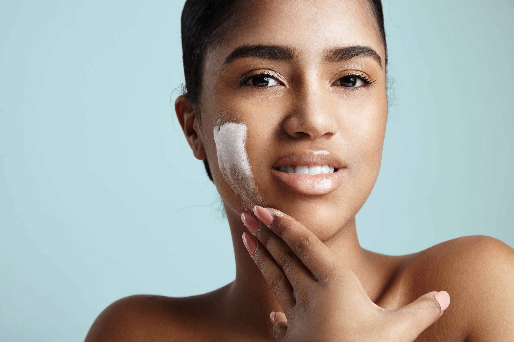 Beautiful female using a skin cleanser to represent gentle cleansing with Croda's Natrafusion SL HA