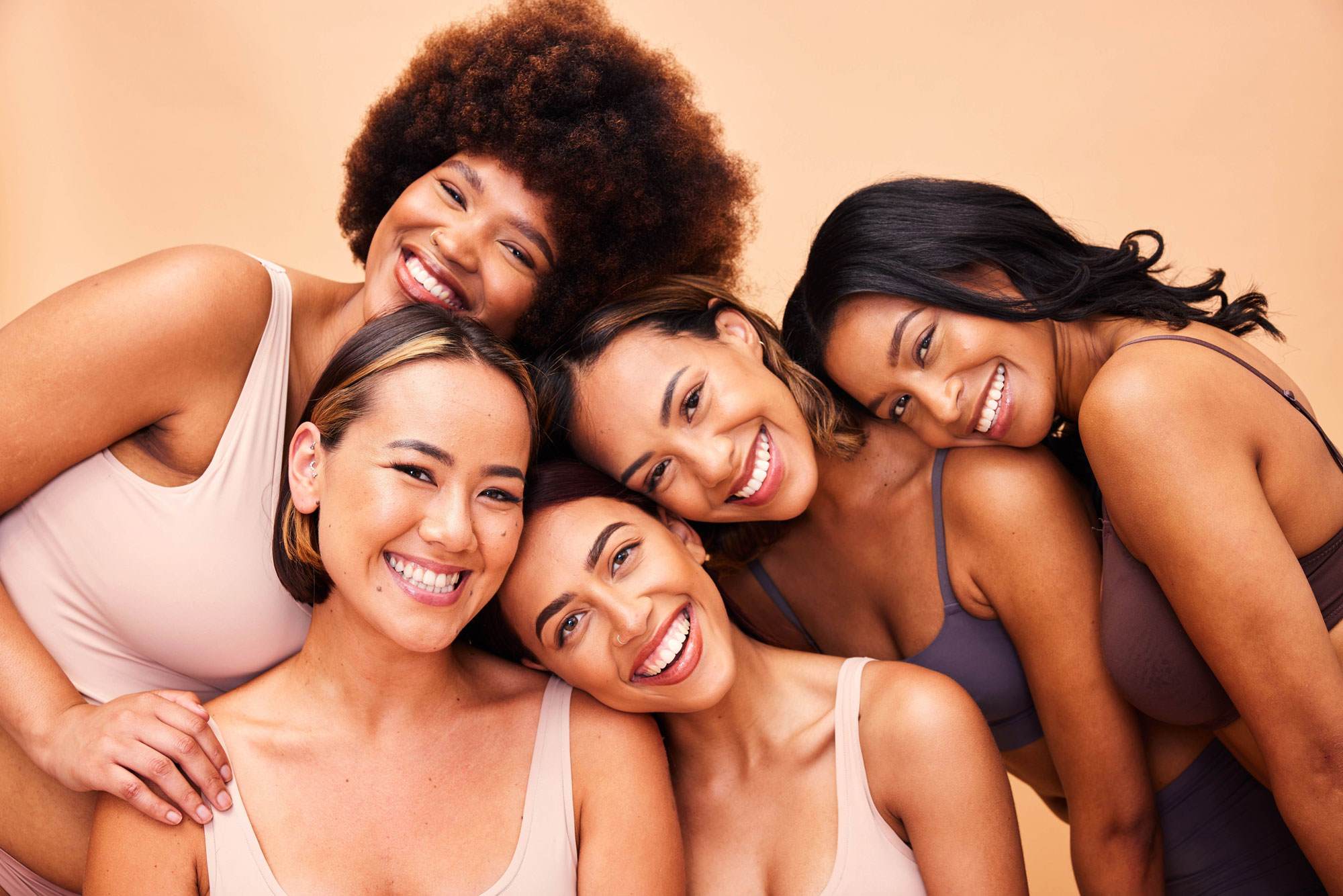 5 women smiling in lighting 