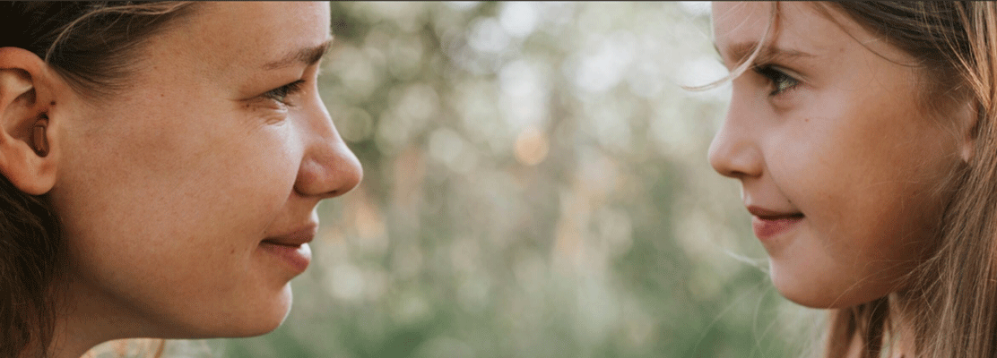 One White woman with brown hair who looks to be in her 30s or 40s looking at one White child with brownish blonde hair.