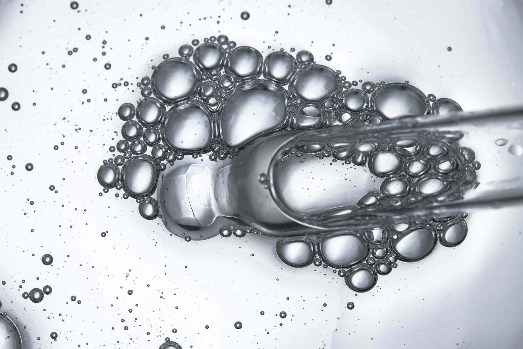 peptides Dropper with bubbles close-up top view landscape skin care actives