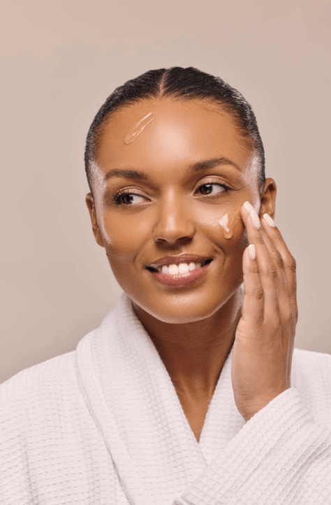 Woman applying a warming makeup remover to her face