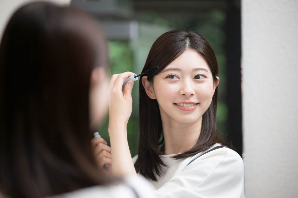 Young east asian woman with long black hair using the flyaway styling stick