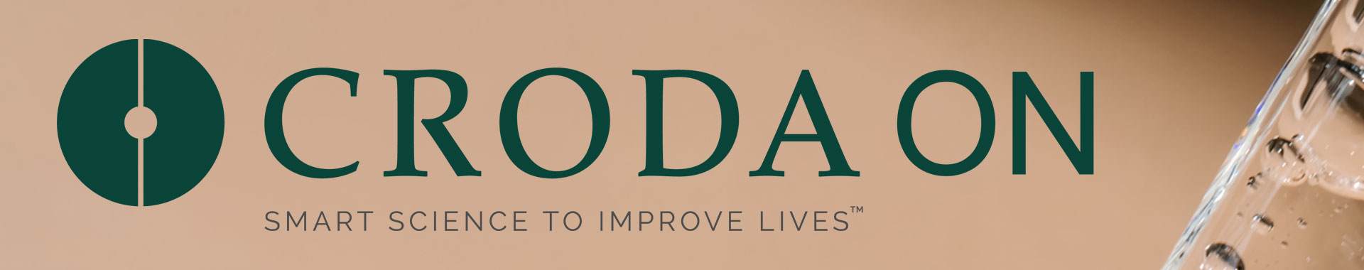 the croda on logo against a backdrop of a glass pippette