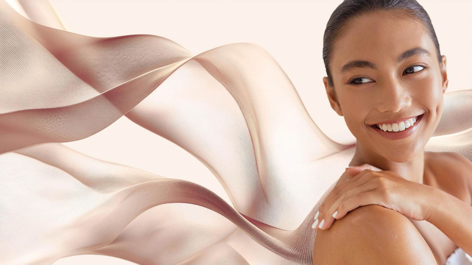 Malvallin - Smiling woman with light brown skin and dark hair draped in flowing fabric