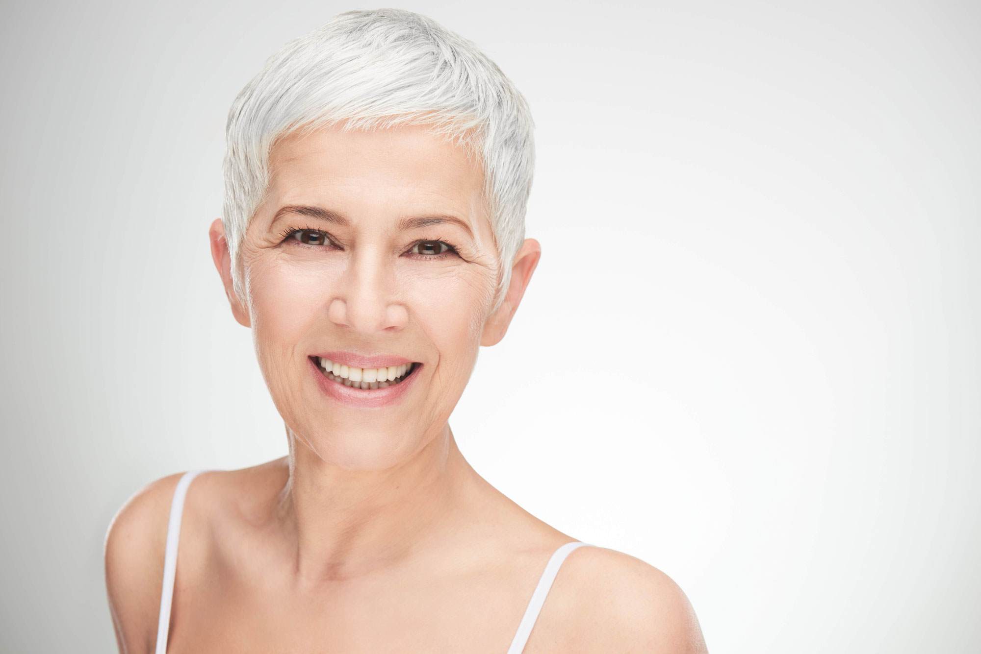 matrixyl older woman with silver hair smiling