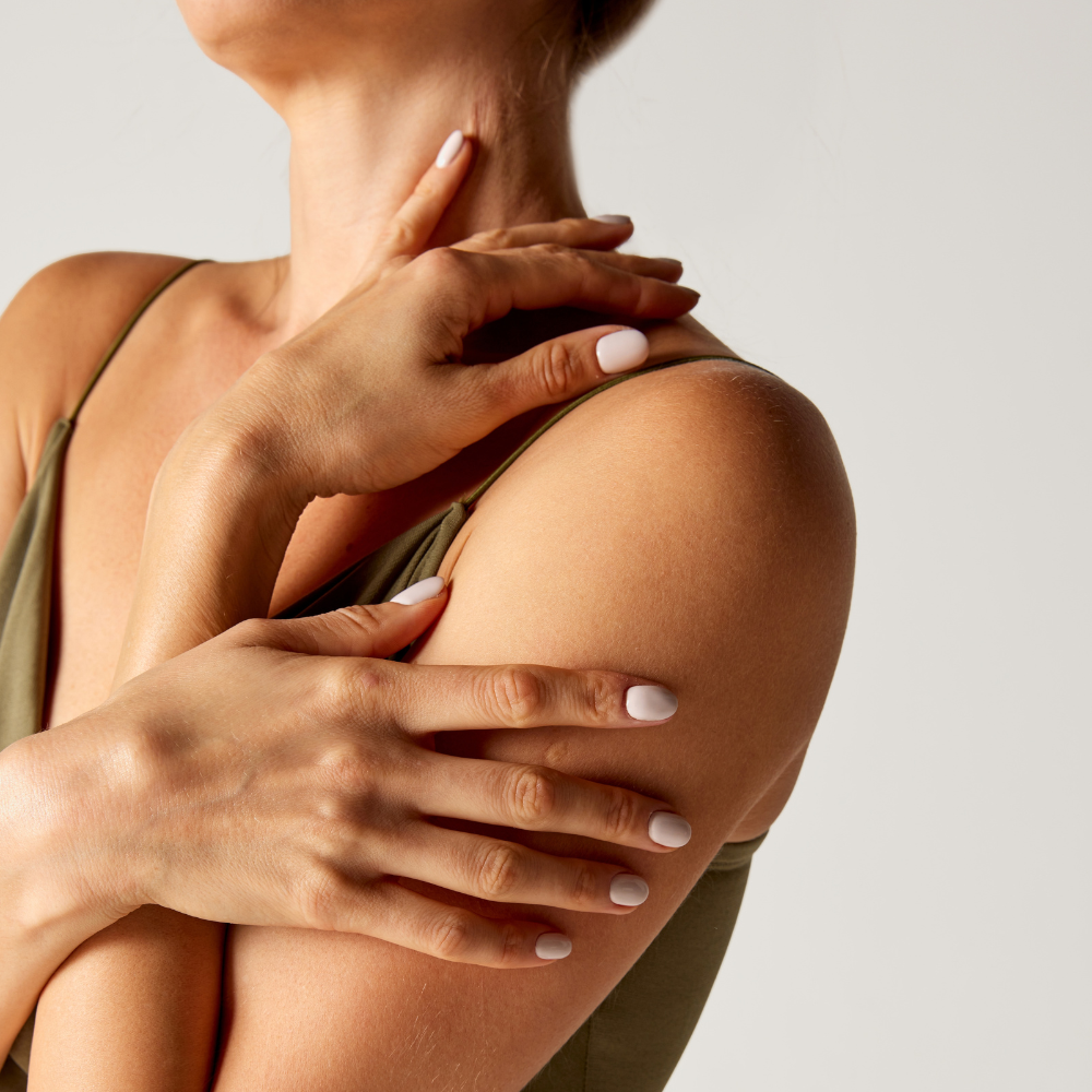 Woman touching her arms