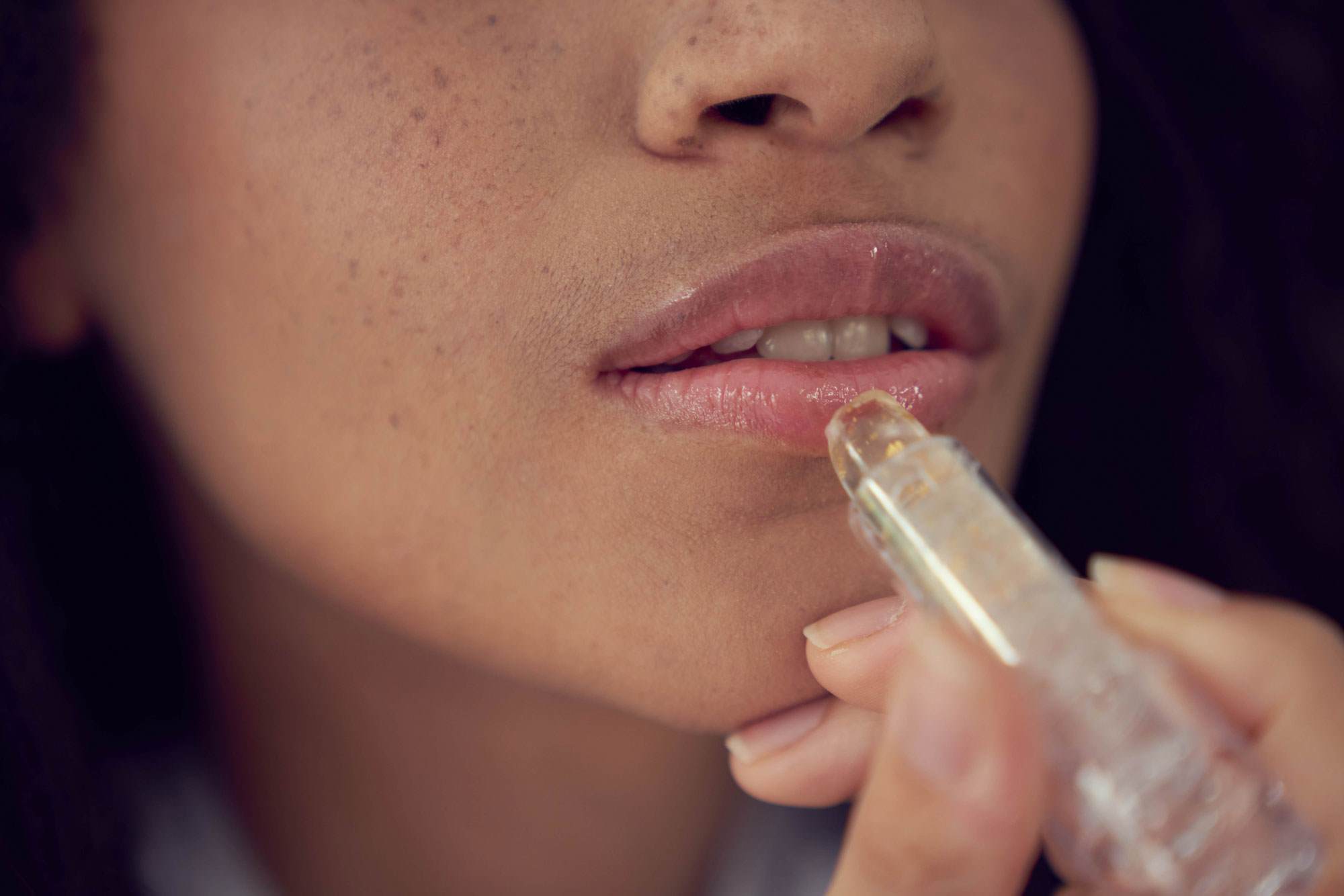 women applying lip stick