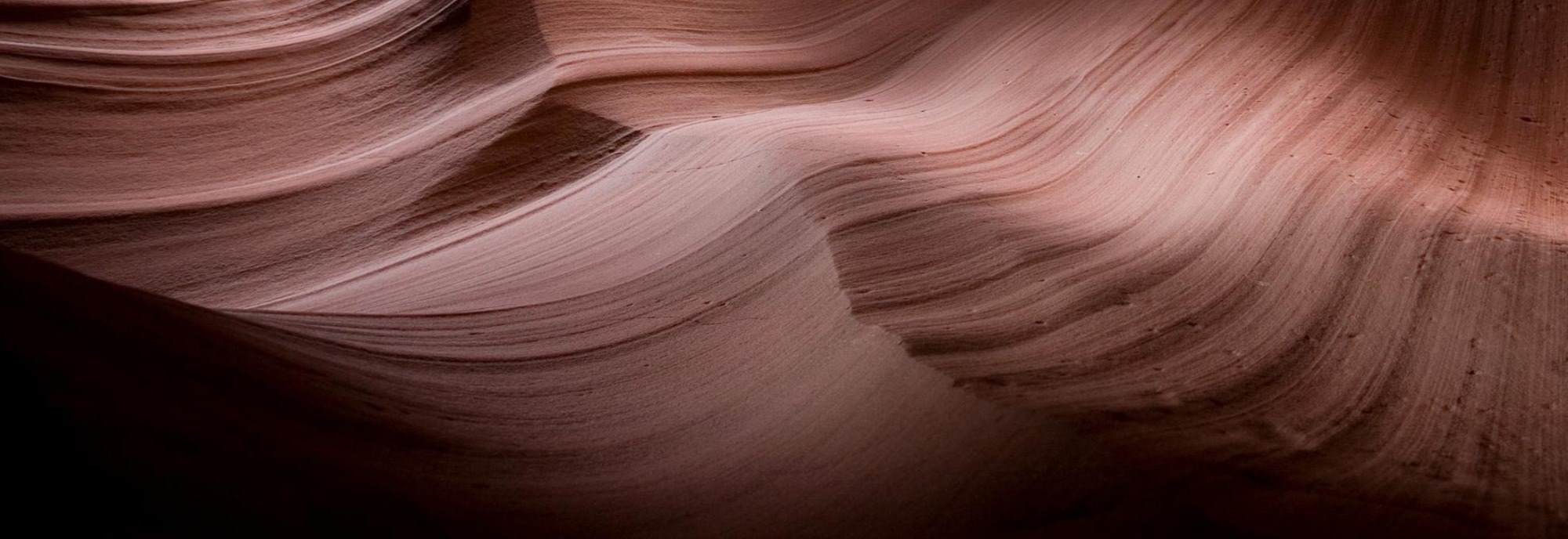 Striated beige and brown rock formation, echoing natural skin tones, symbolising the layered skin barrier and highlighting Ceramide NP as a geoskincare-inspired protective and strengthening ingredient for all climates. 