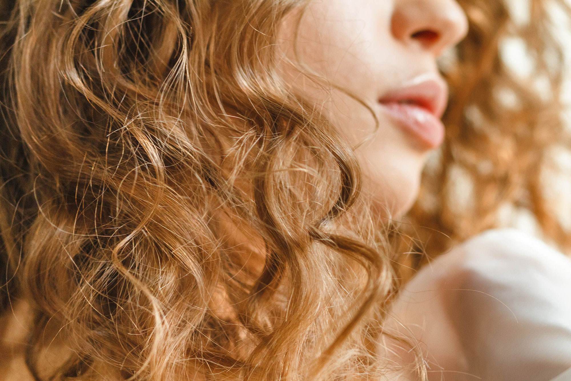 close up of women with curly hair