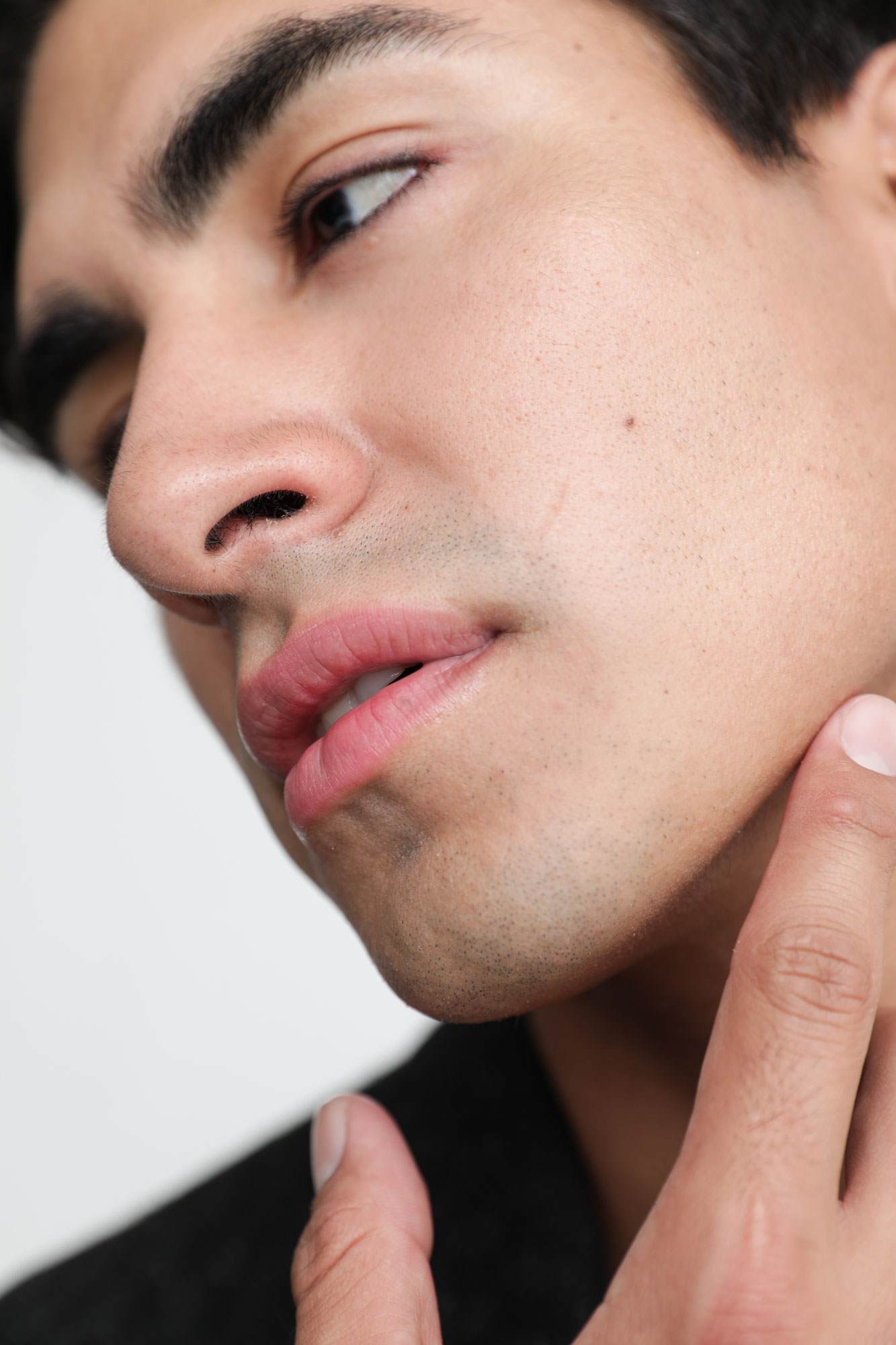 Middle eastern man touching his chin