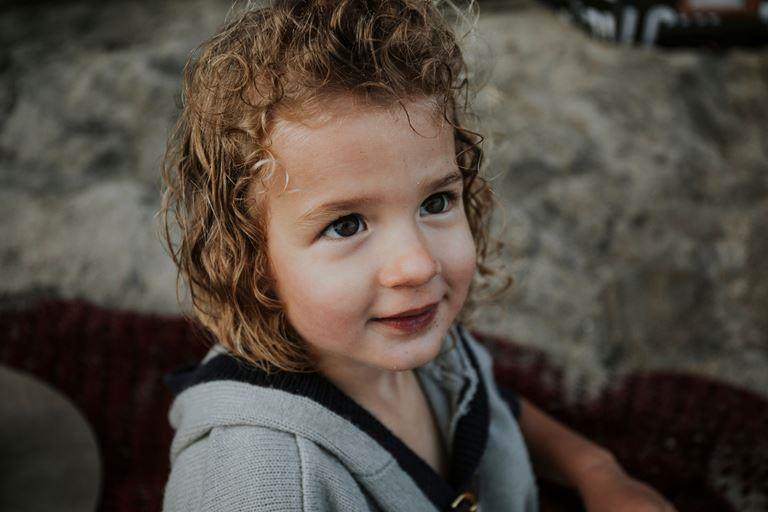 spf boosters - young smiling white girl with blonde curly hair