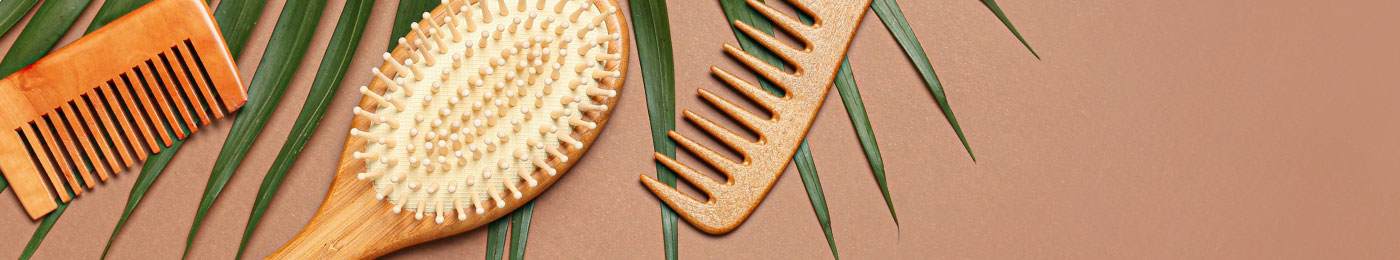 Various types of hair brushes on leaves