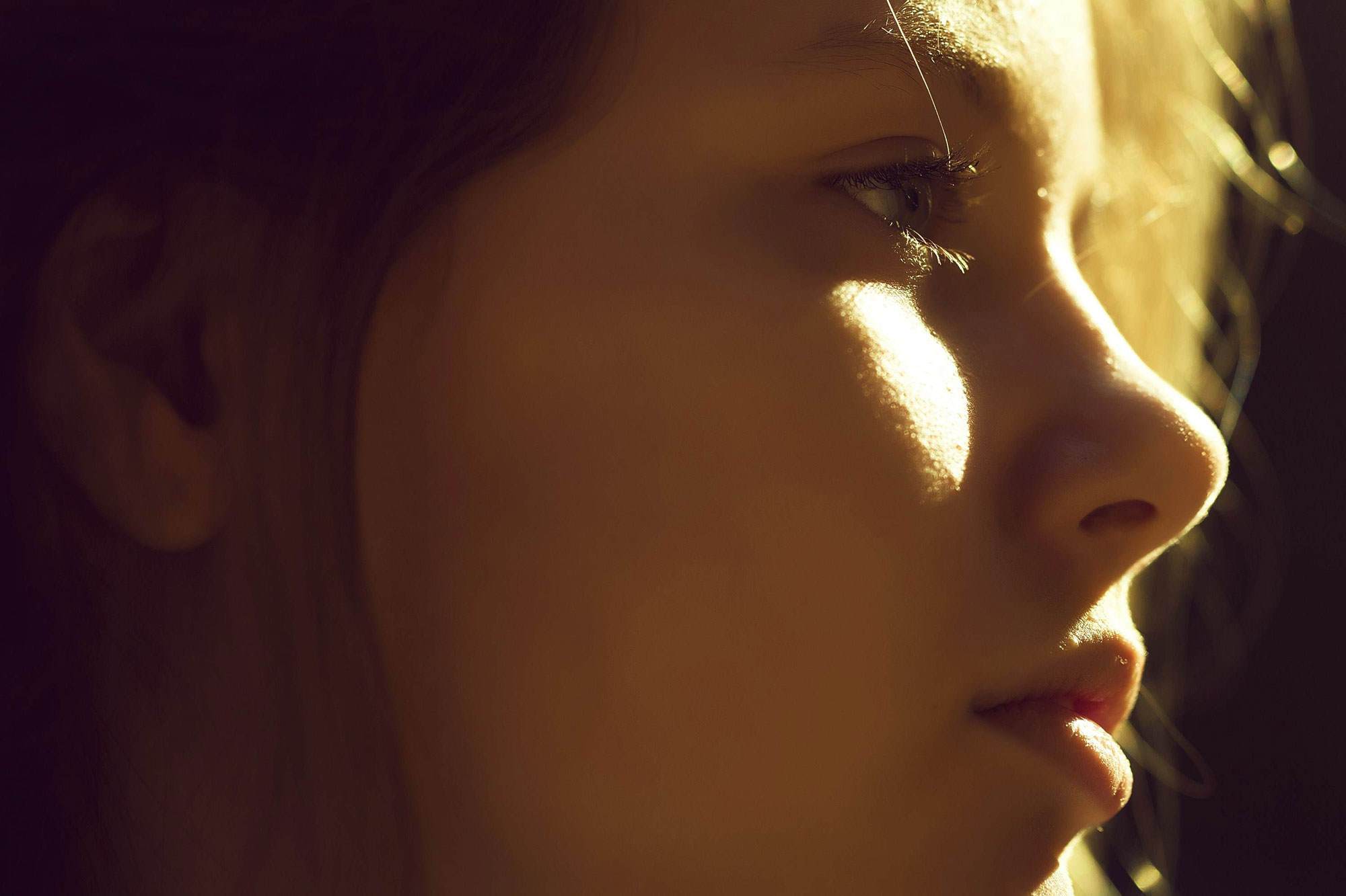 person looking to the side with sun shining on their face